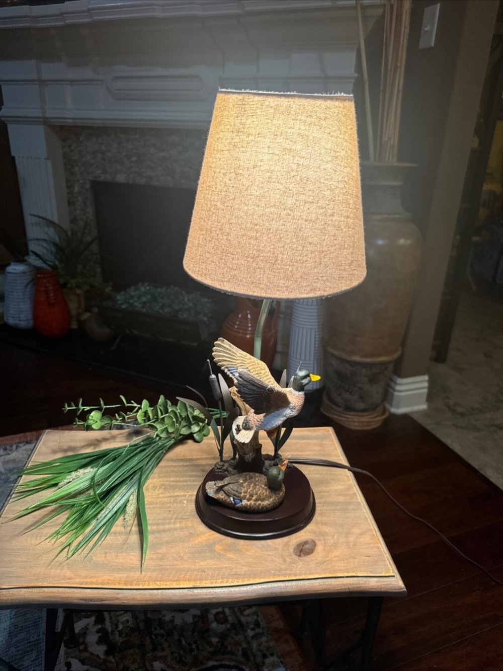 A Flying Duck Table Lamp w/resin duck & cattail sculpture on a round wooden base